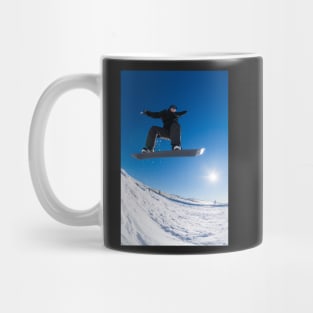 Snowboarder jumping against blue sky Mug